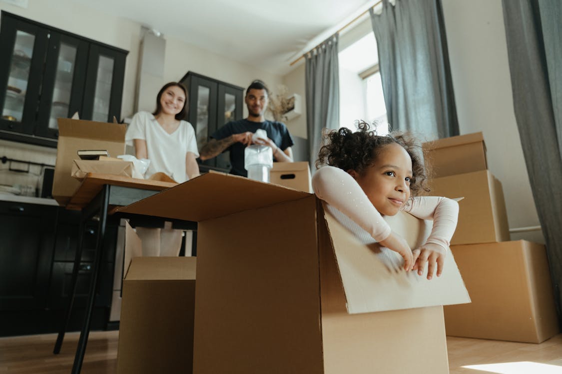 Free Little Girl Playing in a Box Stock Photo