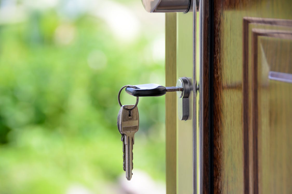 Free Black Handled Key on Key Hole Stock Photo