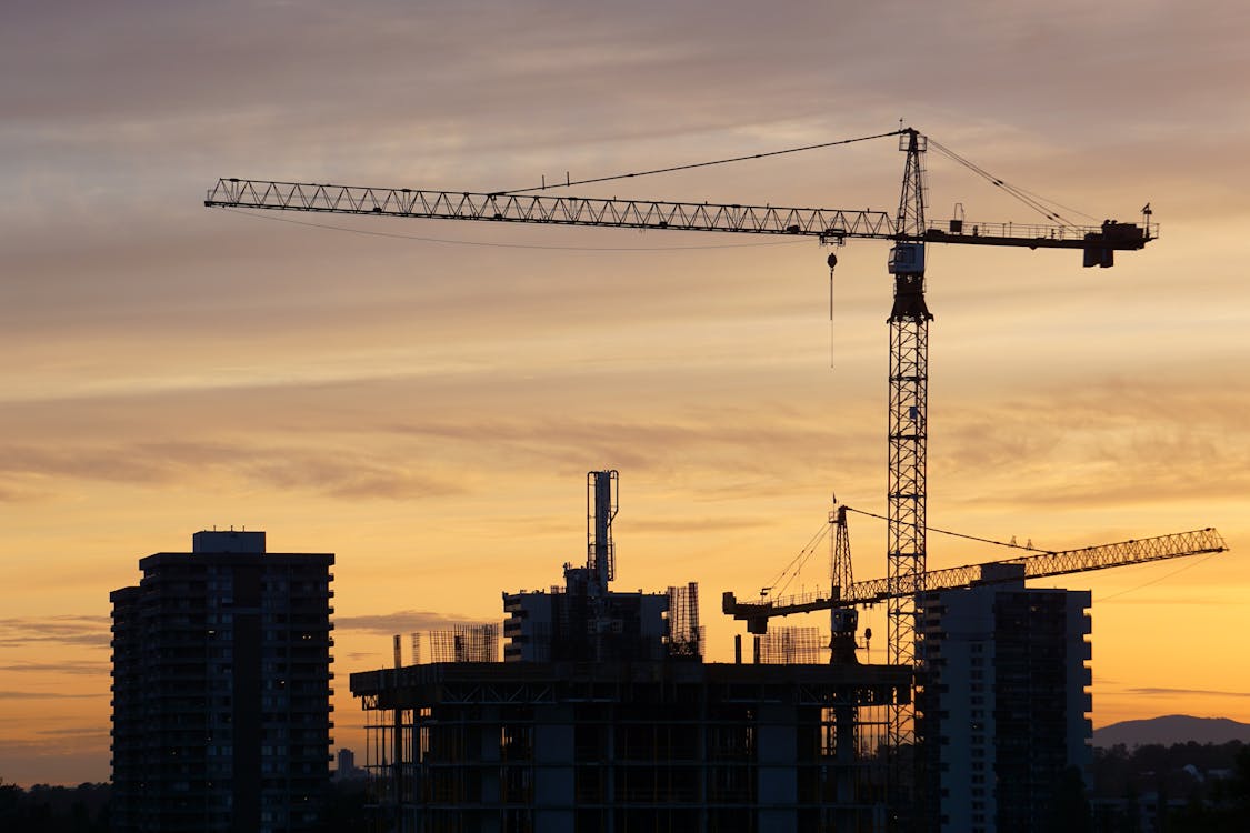 Free Silhouette of Crane Near High Rise Buildings during Sunset Stock Photo