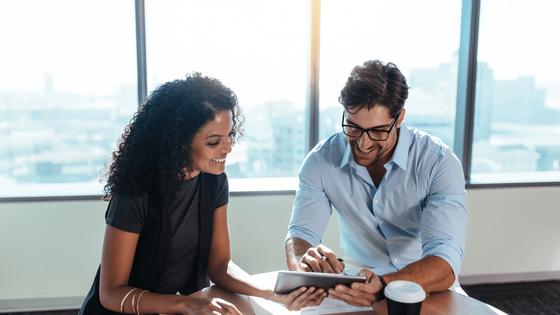 two happy people looking at some data 