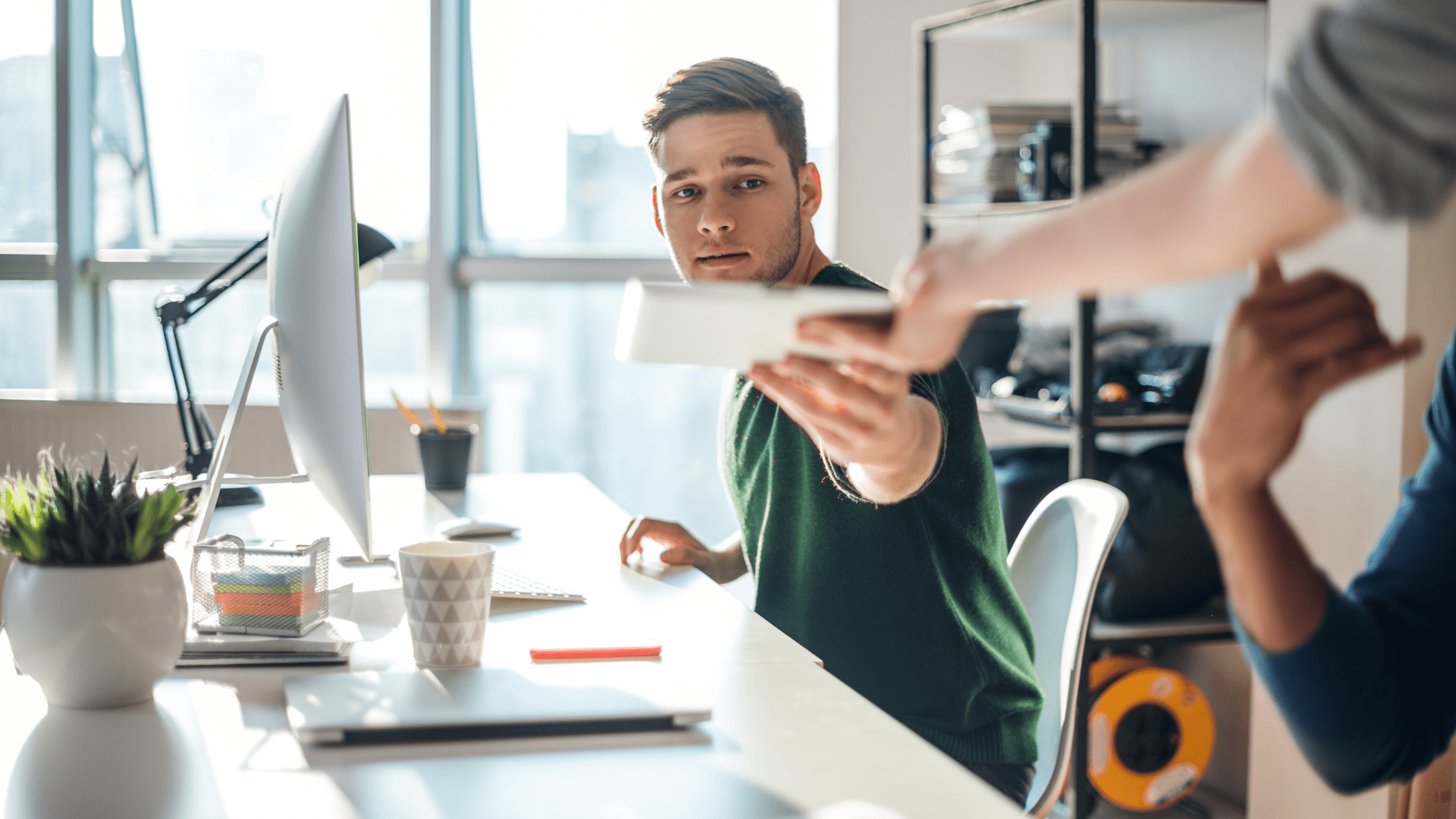 LMI between Lender and Borrower - Image of a an giving a notebook to another person