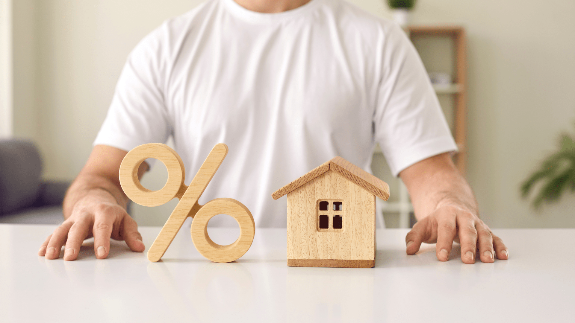 man sitting with property and percentage sign