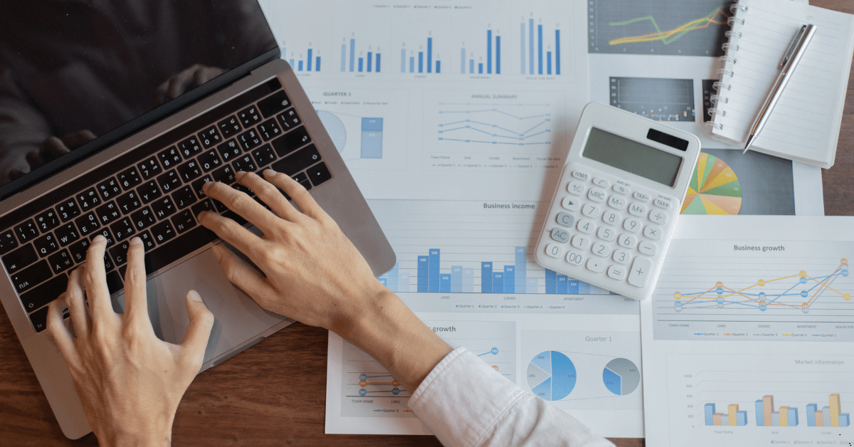 home loan - man using laptop and calculator for calculation of refinancing mortgage