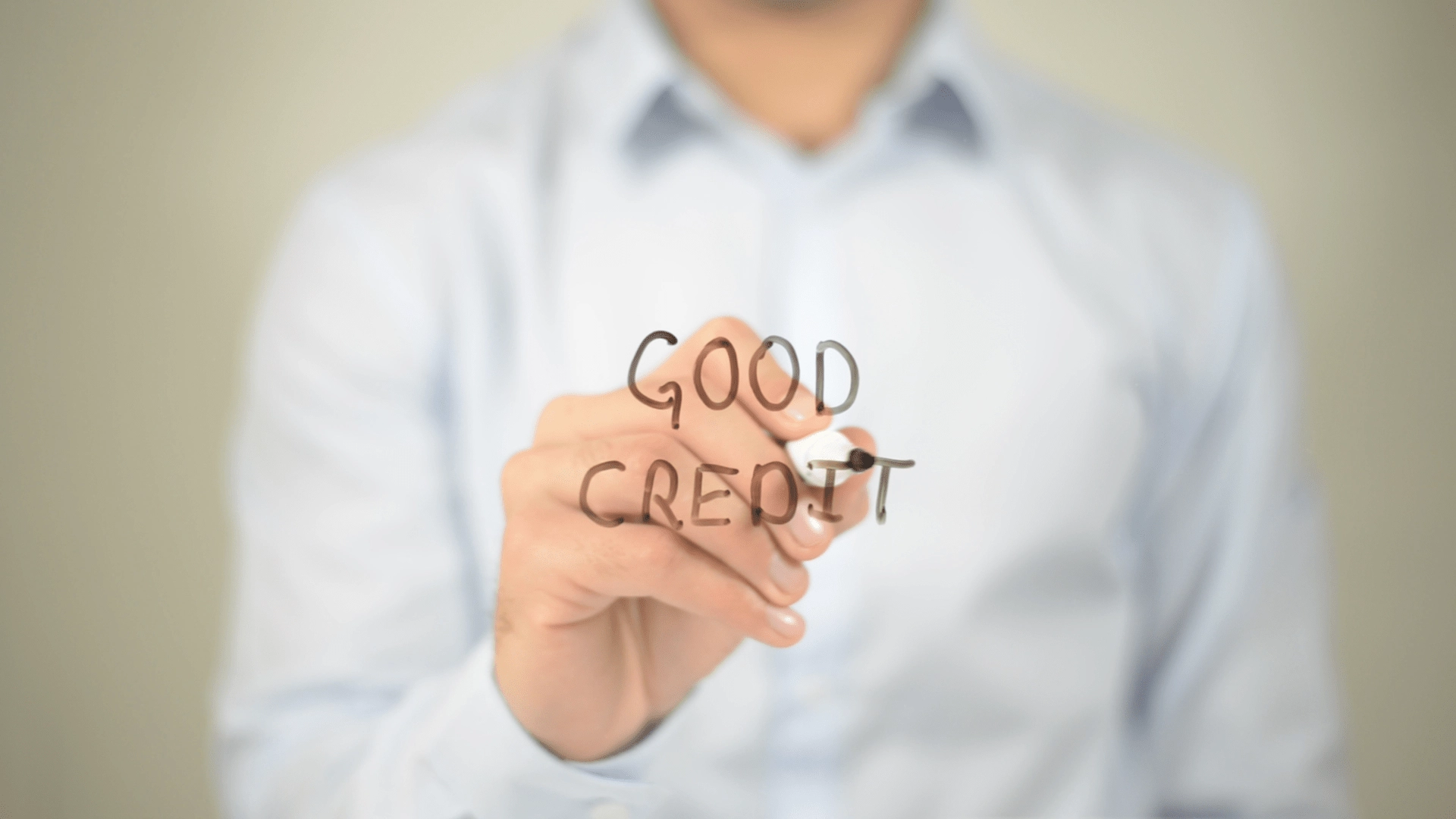 man writing "good credit" with a marker