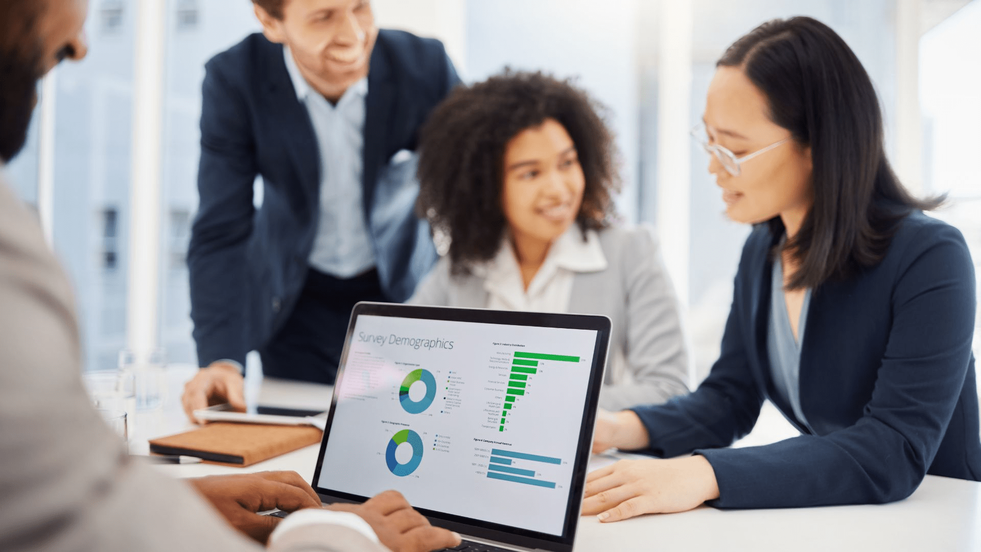 people huddled in a meeting room looking at data