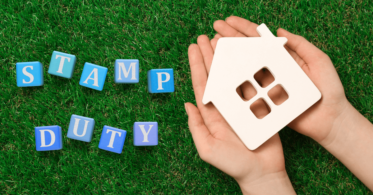 Stamp Duty - What is Stamp Duty - A person showing a dummy house on his hand