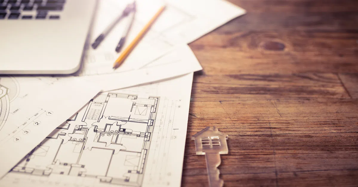 House and Land Packages - Turnkey Convenience where there is a blueprint of a property and pencils and plastic keys of that property