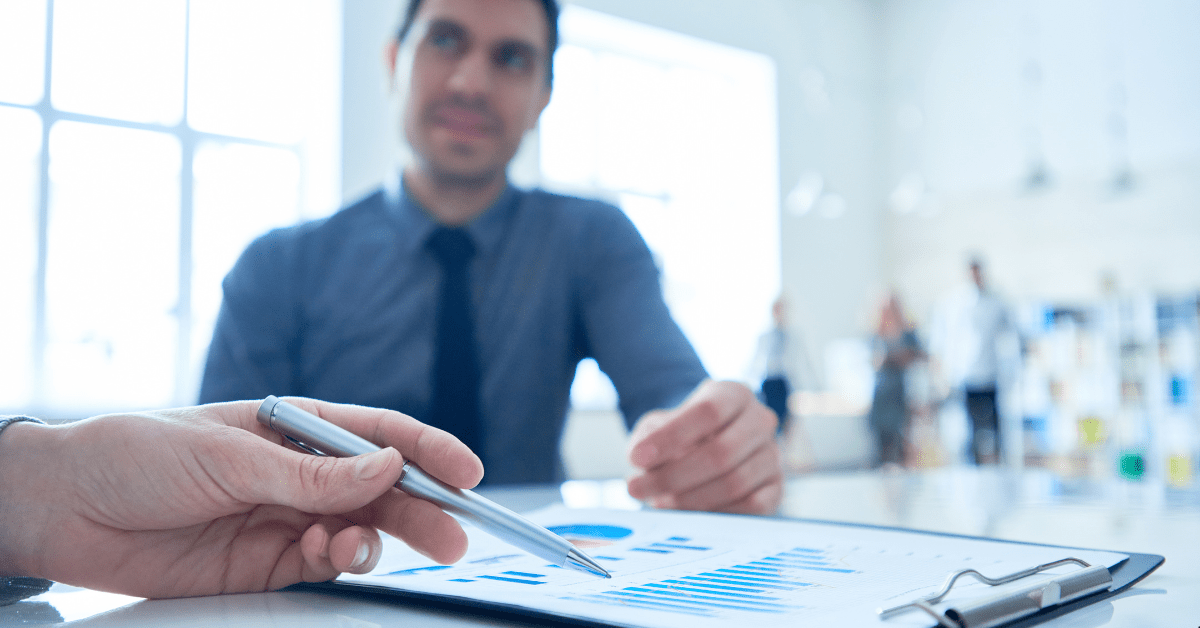 Investment Properties- A person is showing graph to another person on a tab