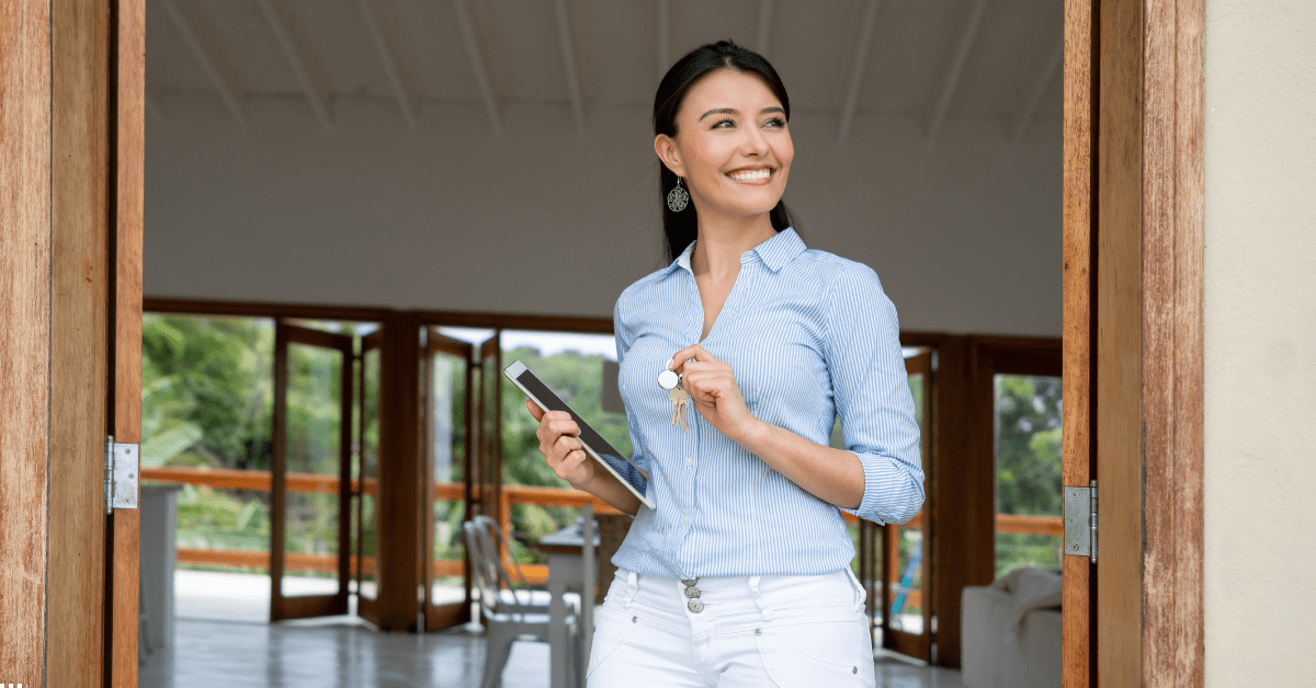 Off Market Property Deals - Woman Holding Keys of a property and also a iPad on hand and smiling 