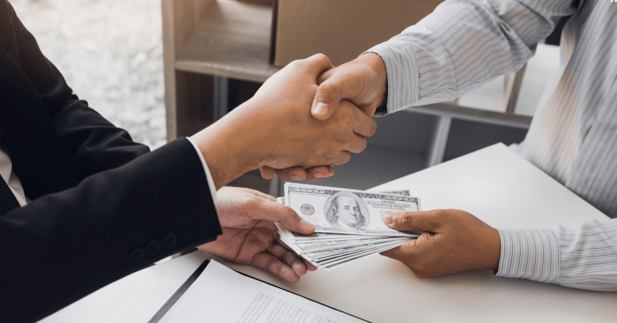 SMSF Borrowing - One person is giving money to another and they both are handshaking meaning an agreement has been done between them