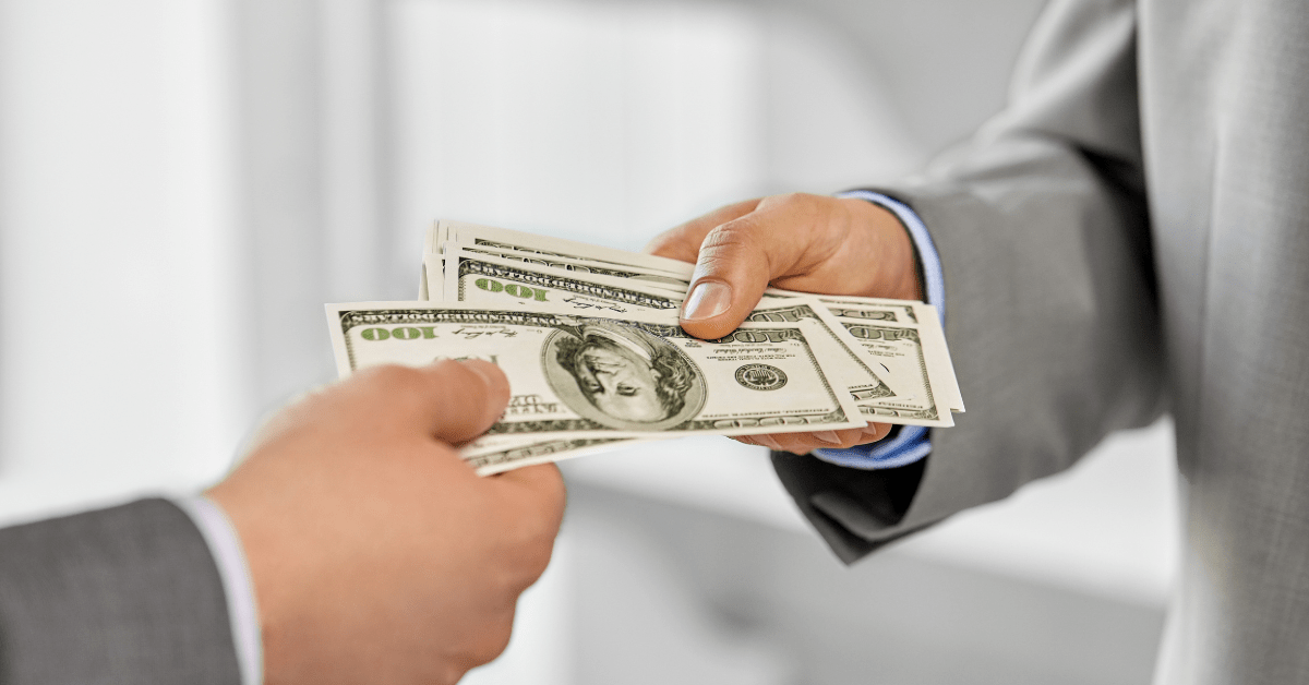 building wealth - image of one person is giving dollars to another person from hand to hand