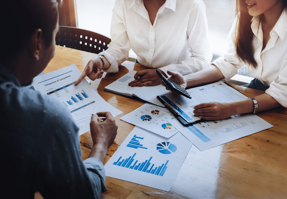 3 professionals using graphs and charts for investment property financing opportunities in Australia