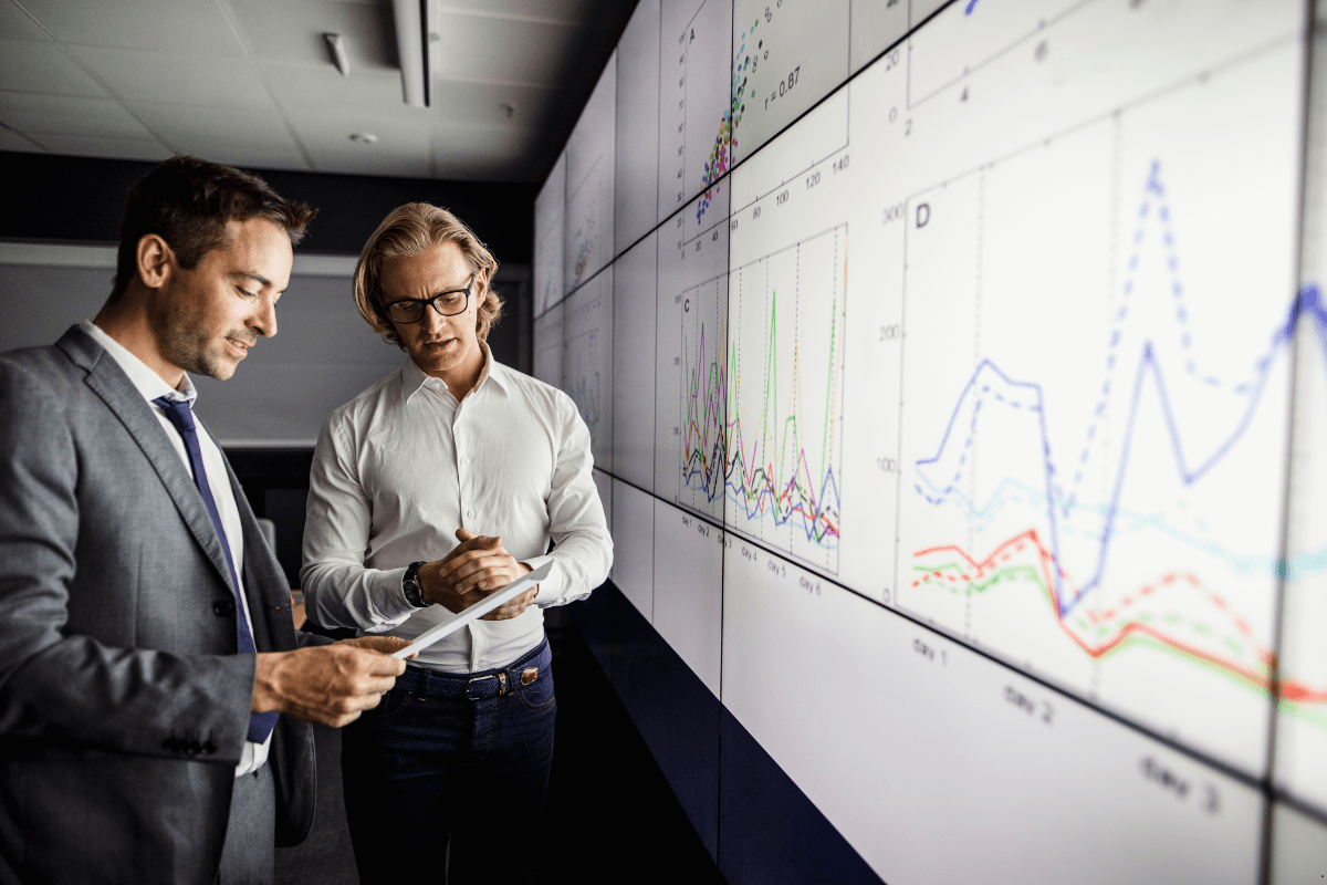 Two persons analysing the current trends in property market