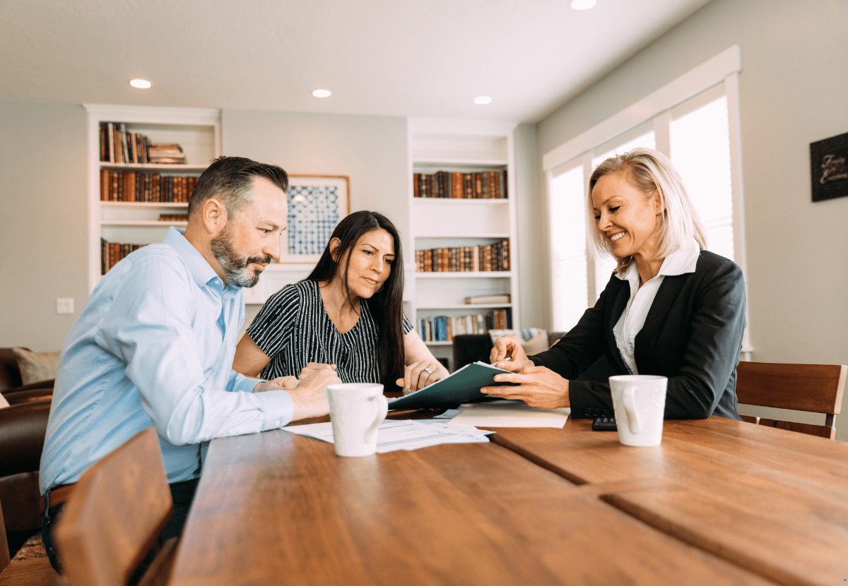 A mortgage broker is guiding a couple for investment property financing