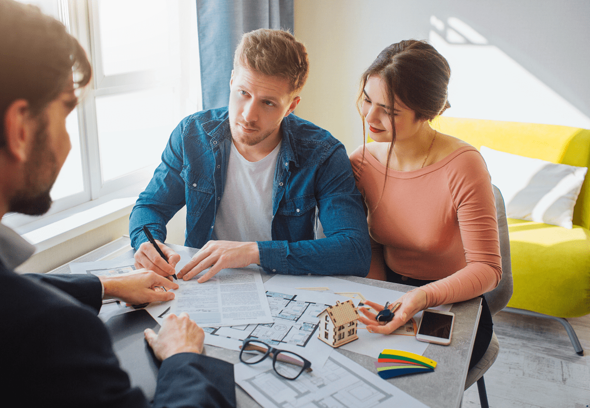 A couple talking to a property broker for investing in property