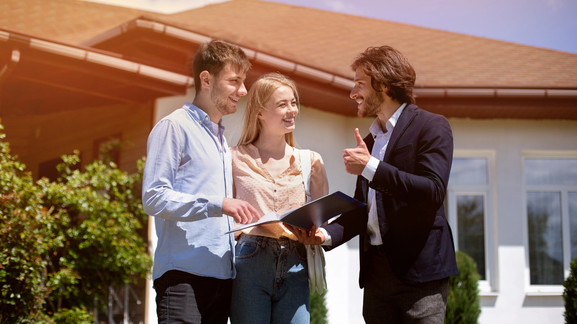 a property professional giving home loan services to his client in front of a house