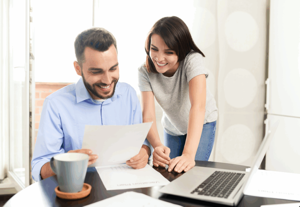 couples looking at a document and smiling with happiness