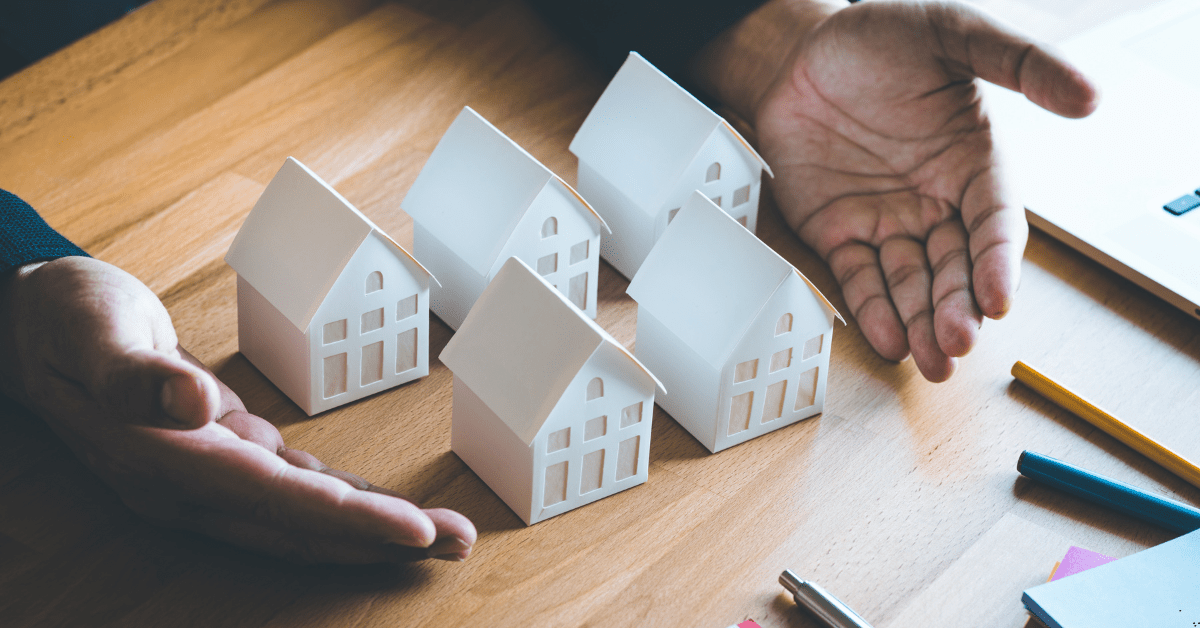 Investment Property - Image of a man showing dummy houses