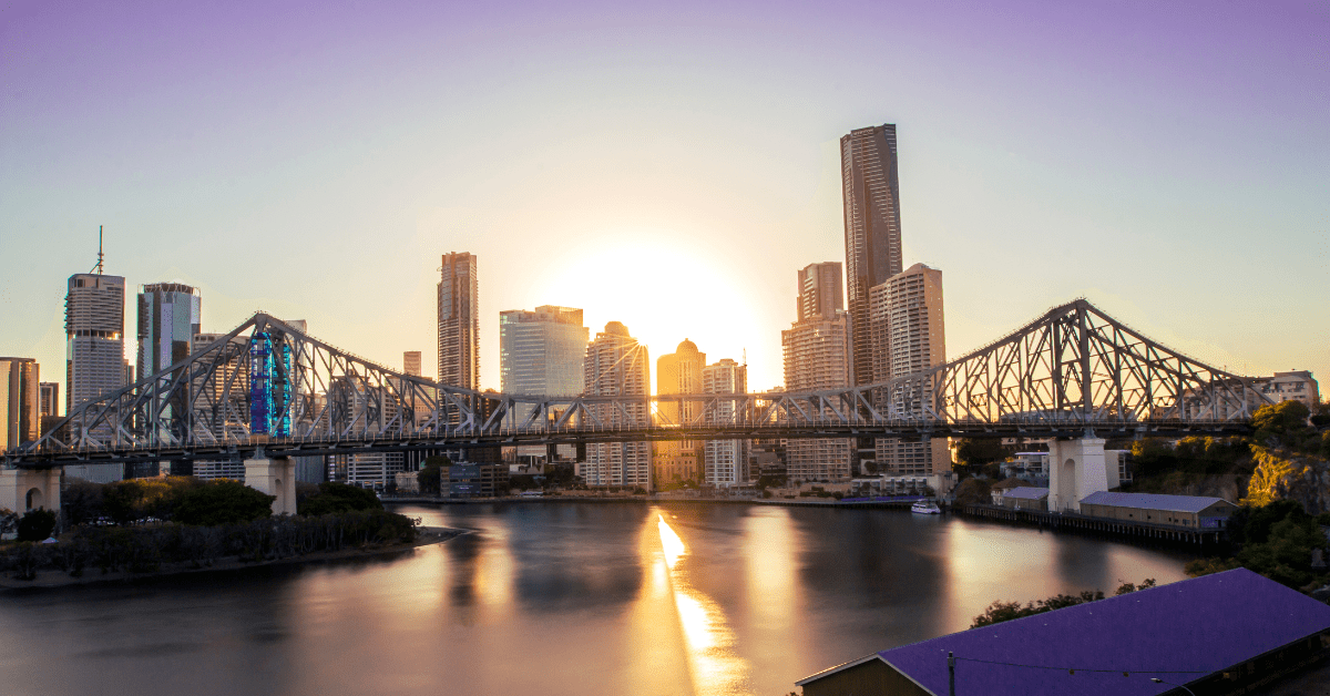 Brisbane city view with standing skyscrapers indicating to invest in Australia