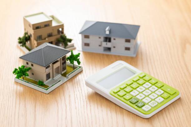 cost of buying an apartment - dummy houses with a calculator indicating calculation for buying an apartment