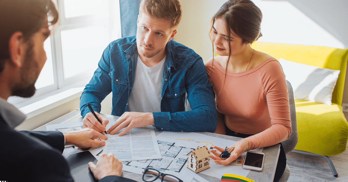 buy property SMSF property investment - image of a couple giving signature when buying property
