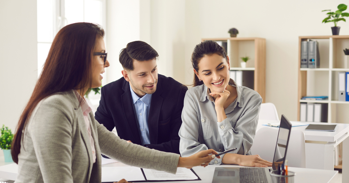 Investing in SMSF Property - Image of an advisor giving professional financial advice to a couple on investment property