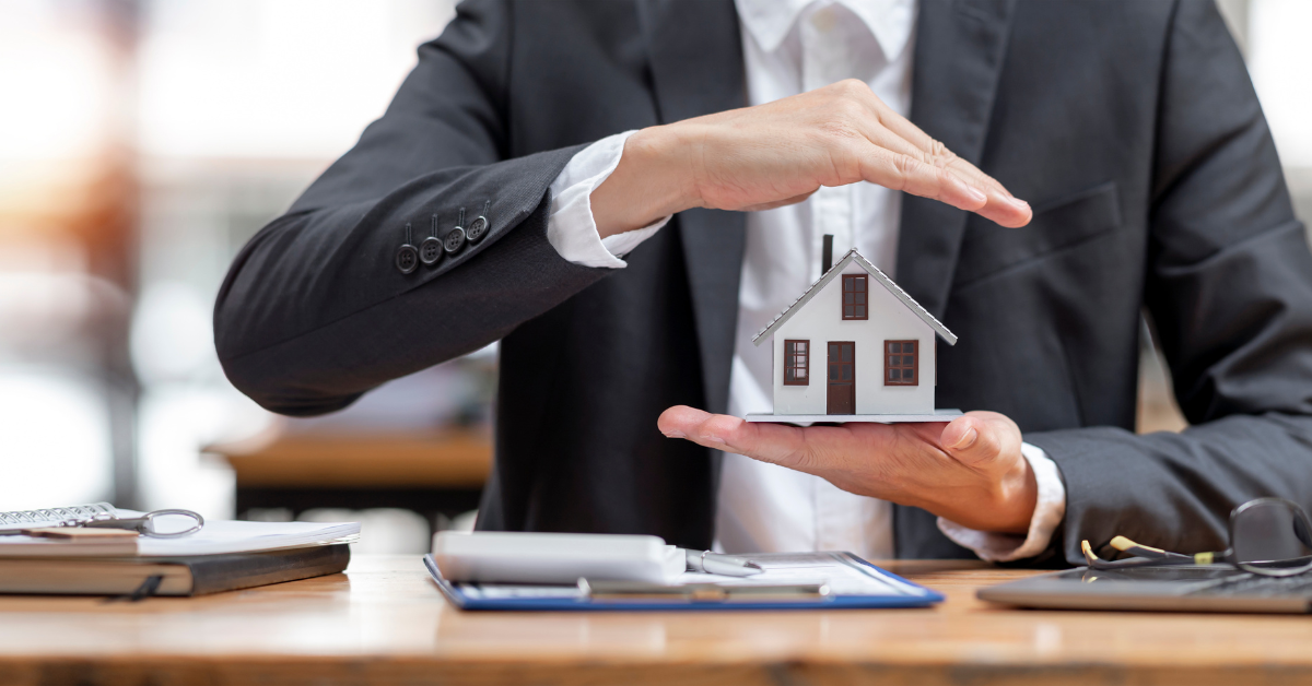 Property Market Myth - image of man holding a dummy home