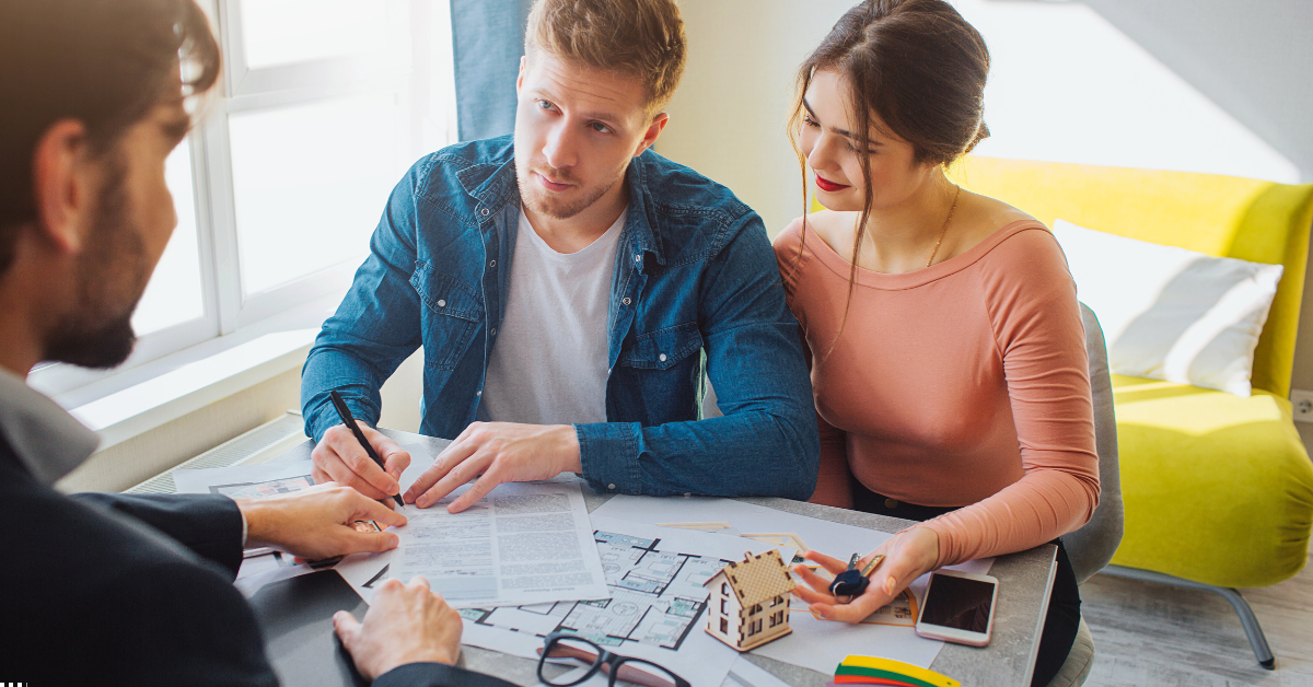 buy property SMSF property investment - image of a couple giving signature when buying property