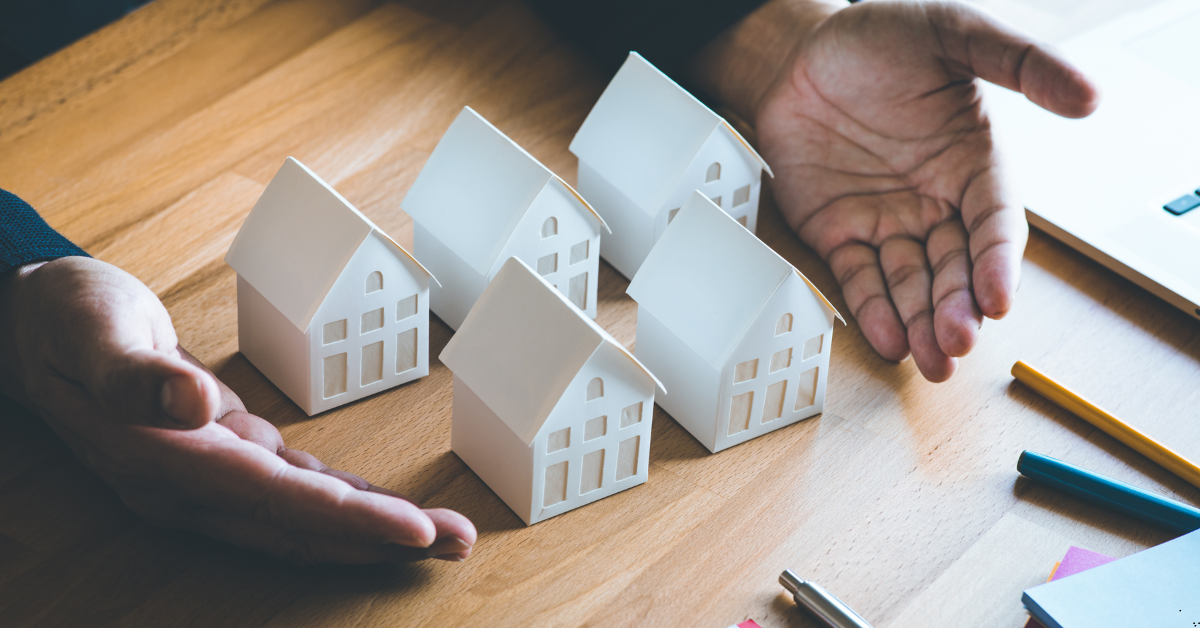 Investment Property - Image of a man showing dummy houses