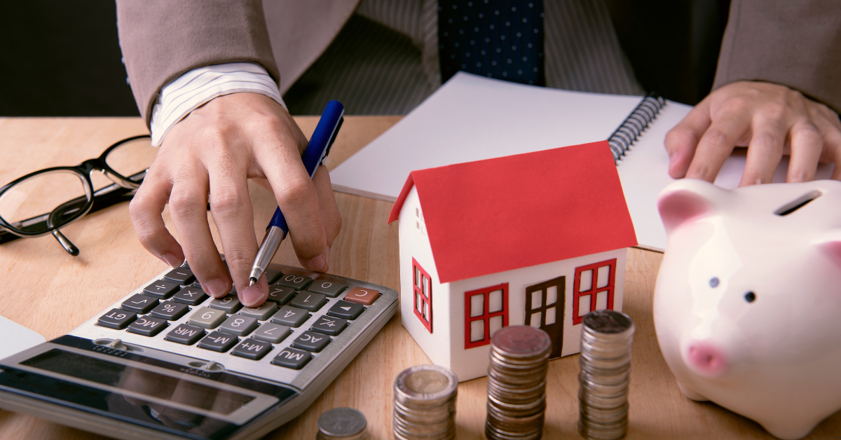 a person is calculating property investment journey using a calculator on his table