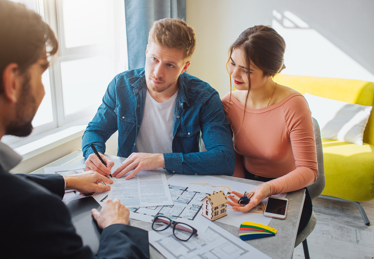 A couple talking to a property broker for investing in property