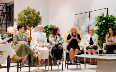 Group of women seated in a stylish interior, engaging in a discussion about property investment and financial empowerment, surrounded by greenery and elegant decor.